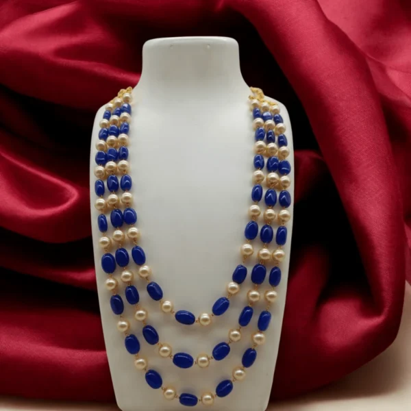 Traditional Kundan style beaded jewelry with blue beads and golden pearls