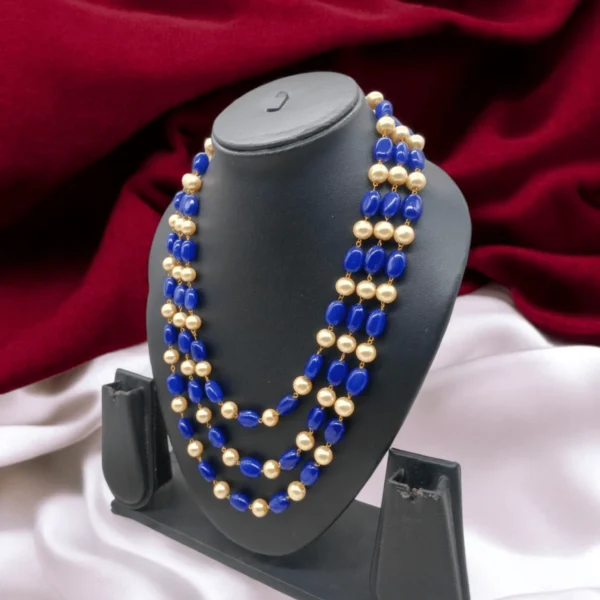 Festive jewelry set featuring blue and gold multilayer necklace