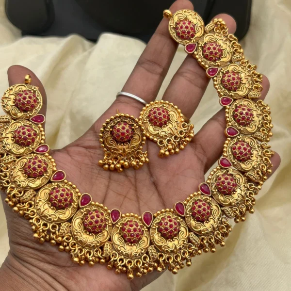 Traditional South Indian choker necklace with antique gold plating and ruby red stone work.